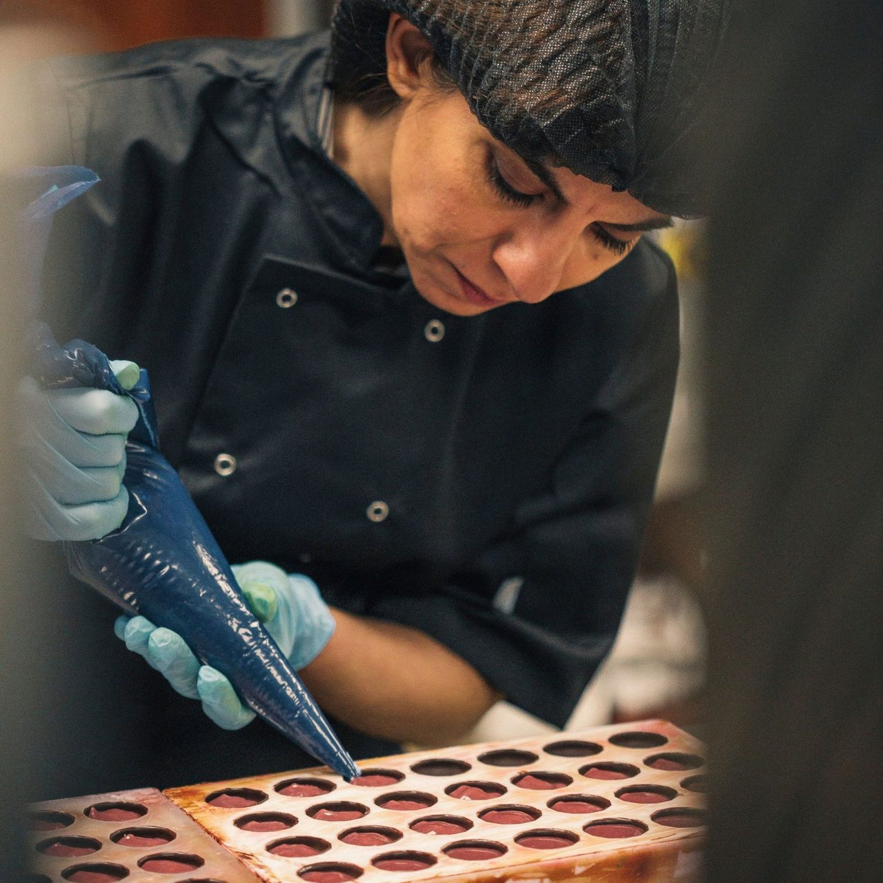 Mona Shah piping chocolate by hand in the Ely workshop